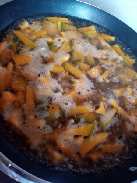 Squash being cooked in a pan.