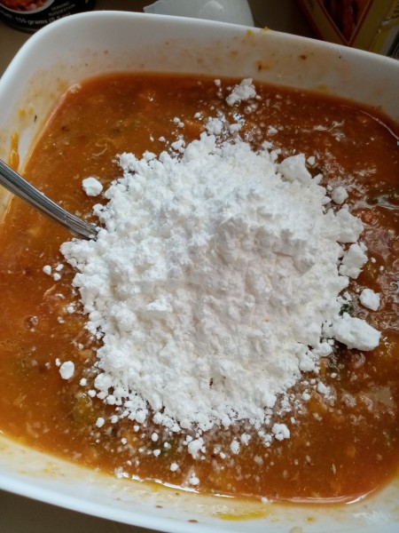 Adding cornstarch to the mixture.