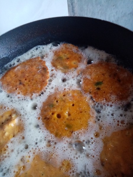 Frying the pancakes in a pan.