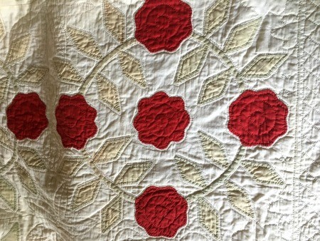 An old quilt done in white and red.