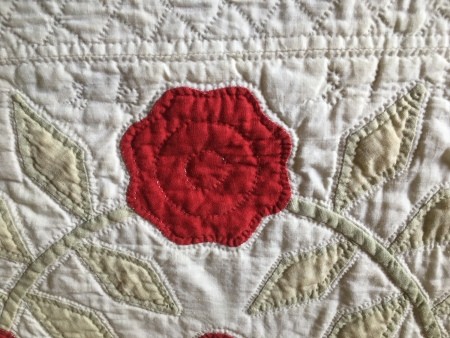An old quilt done in white and red.