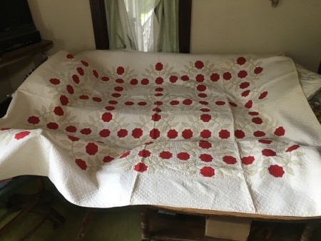 An old quilt done in white and red.