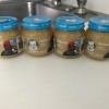 Four jars of baby food on a counter.