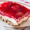 A square of pretzel salad with a strawberry jello topping.