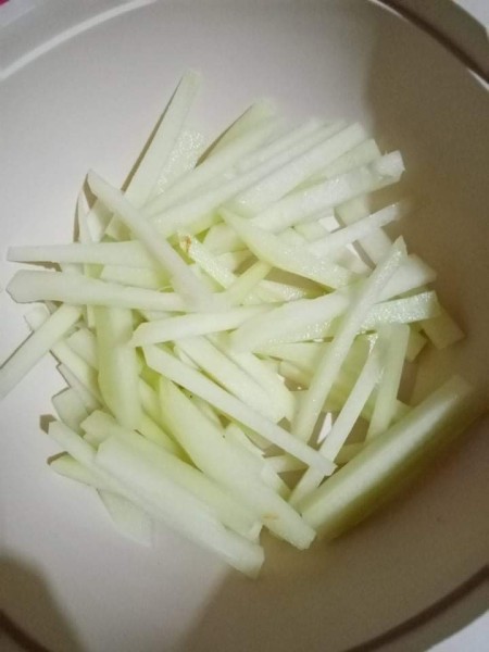 Chayote cut into long thin pieces.
