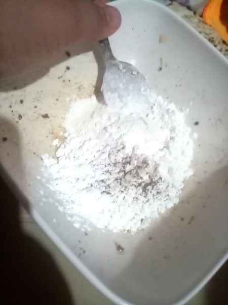 Mixing flour and spices together.