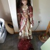 A decorative doll in a fancy dress.