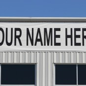 A building with a "Your Name Here" banner on the front.