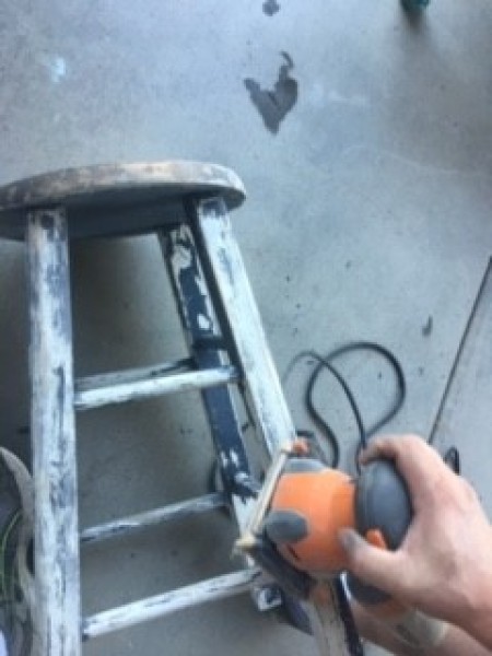 Distressed Finish Stool - using a hand sander on a stool