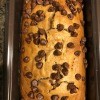 A baked loaf of almond butter chocolate chip bread in the pan.