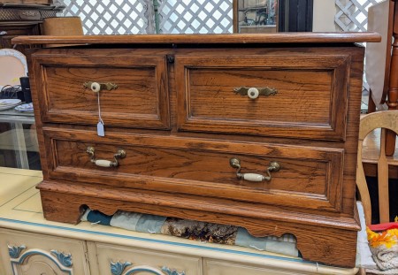 A cedar chest with a drawer at the bottom.