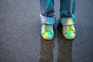 Colorful Paint splatters on shoes and jeans.