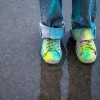 Colorful Paint splatters on shoes and jeans.