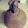 Identifying Old Equipment? - rusty flat bottomed iron ball with a pulley style wheel mounted on top