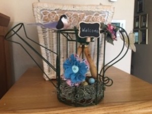 Topiary Watering Can Bird's Nest Decor - finished piece with faux bird and flowers attached