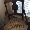 An antique chair with a cane seat.