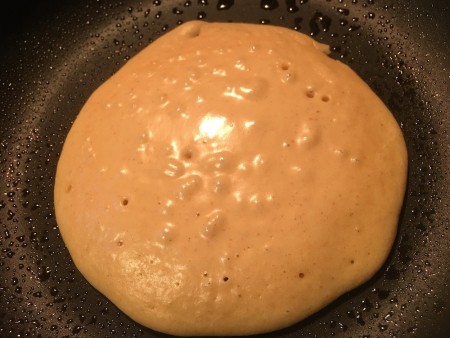 Cooking the pancake in a frying pan.