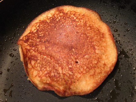 Cooking the pancake in a frying pan.