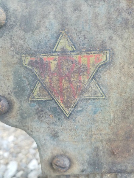 A triangular shaped badge on a piece of equipment.