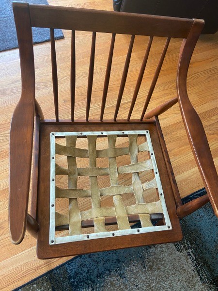 The woven seat bottom of a wooden chair.