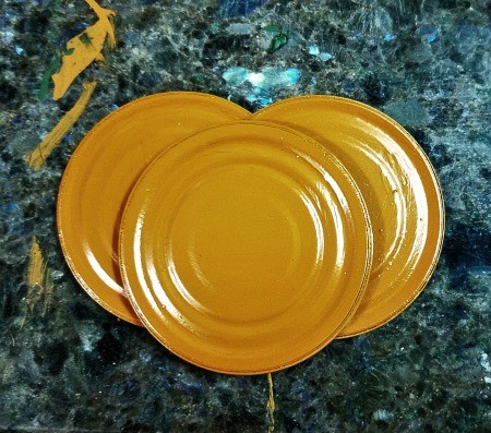 Lid Pumpkin Wall Hanging - three lids painted orange
