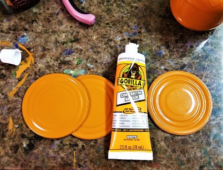 Lid Pumpkin Wall Hanging - painted lids and tube of glue