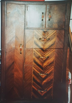 A wooden Art Deco wardrobe.