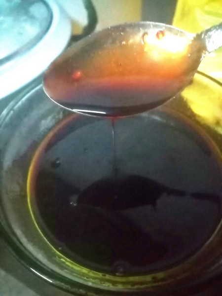 A spoon with barbecue sauce.