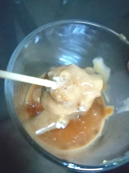 Adding fish cakes to sauce.