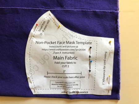 Non Pleated Child's Mask - main fabric pattern pinned to purple fabric