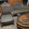 An antique chair with matching loveseat and a coffee table.