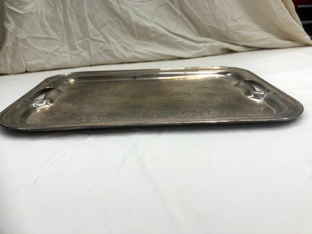 A silver tray on a white surface.