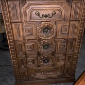 A ornately carved Bassett chest of drawers.