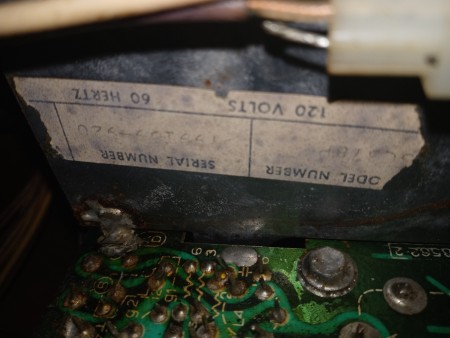 The label with model and serial number of a record player cabinet.