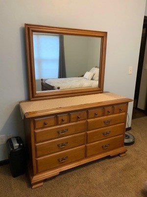 A dresser with a mirror.