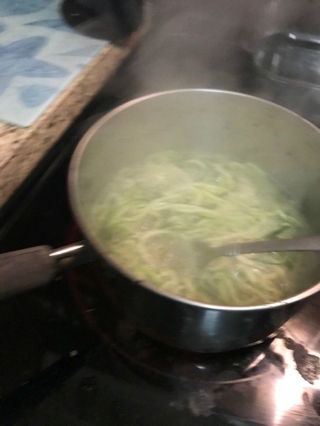 Steaming the zucchini spiral noodles.