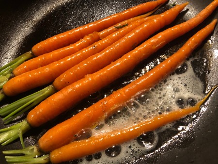 Roasting carrots in a frying pan.