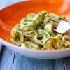 A plate of tortellini with pesto.