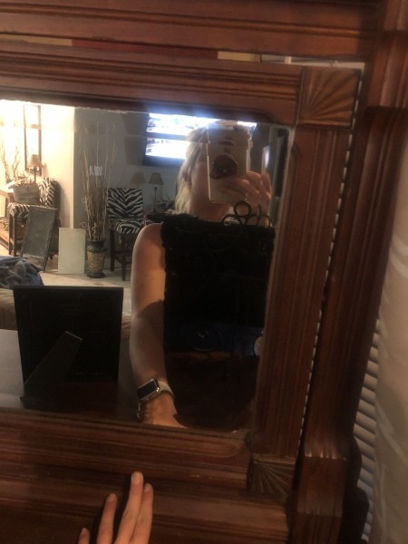 A mirror on a dresser.