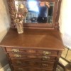 An antique dresser with a mirror.