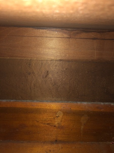 The inside of an antique dresser.