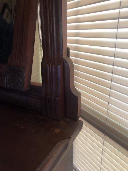 The side of an antique dresser.