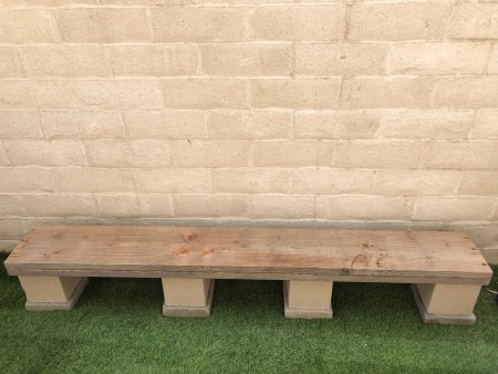 A low shelf on concrete blocks.