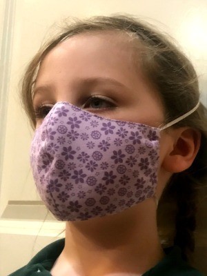 Non Pleated Child's Mask - child wearing the purple floral mask