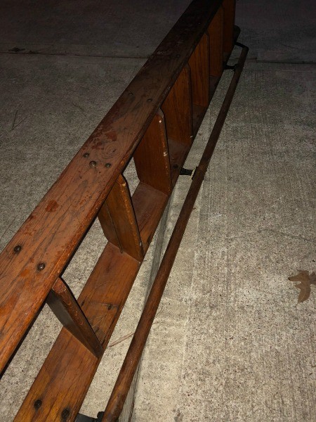 A wooden ladder with a handle on the side.