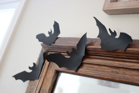 Simple Bat Garland/Bat Wall  -Decorations - four paper bats on the corner of a wood frame