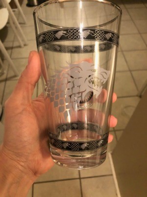 A drinking glass with silver markings.