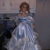 A porcelain doll in a blue dress.