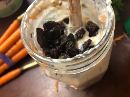 Adding raisins to the oat mixture.