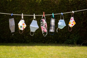 A collection of face masks hanging on a line.